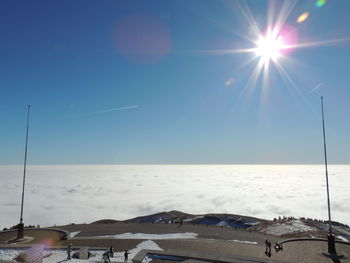 Scenic view of snowcapped mountains against sky on sunny day