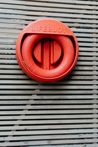 Close-up of life belt on patterned wooden wall