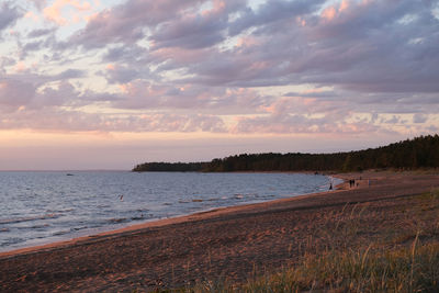 Scenic view of beach against sky during sunset