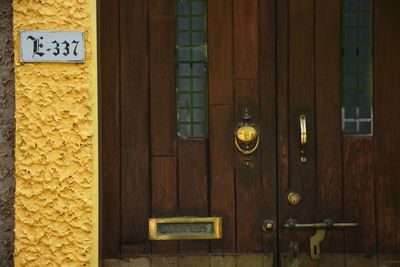 Yellow text on brick wall