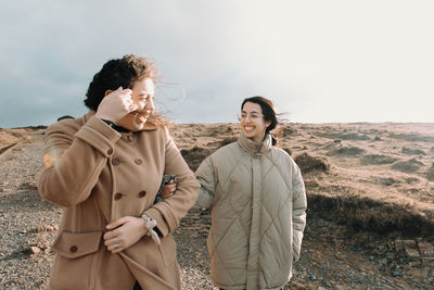 Young woman standing against mountain