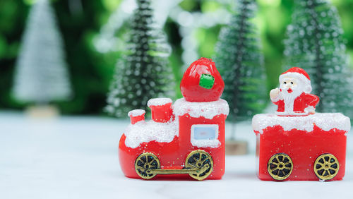 Close-up of stuffed toy against trees