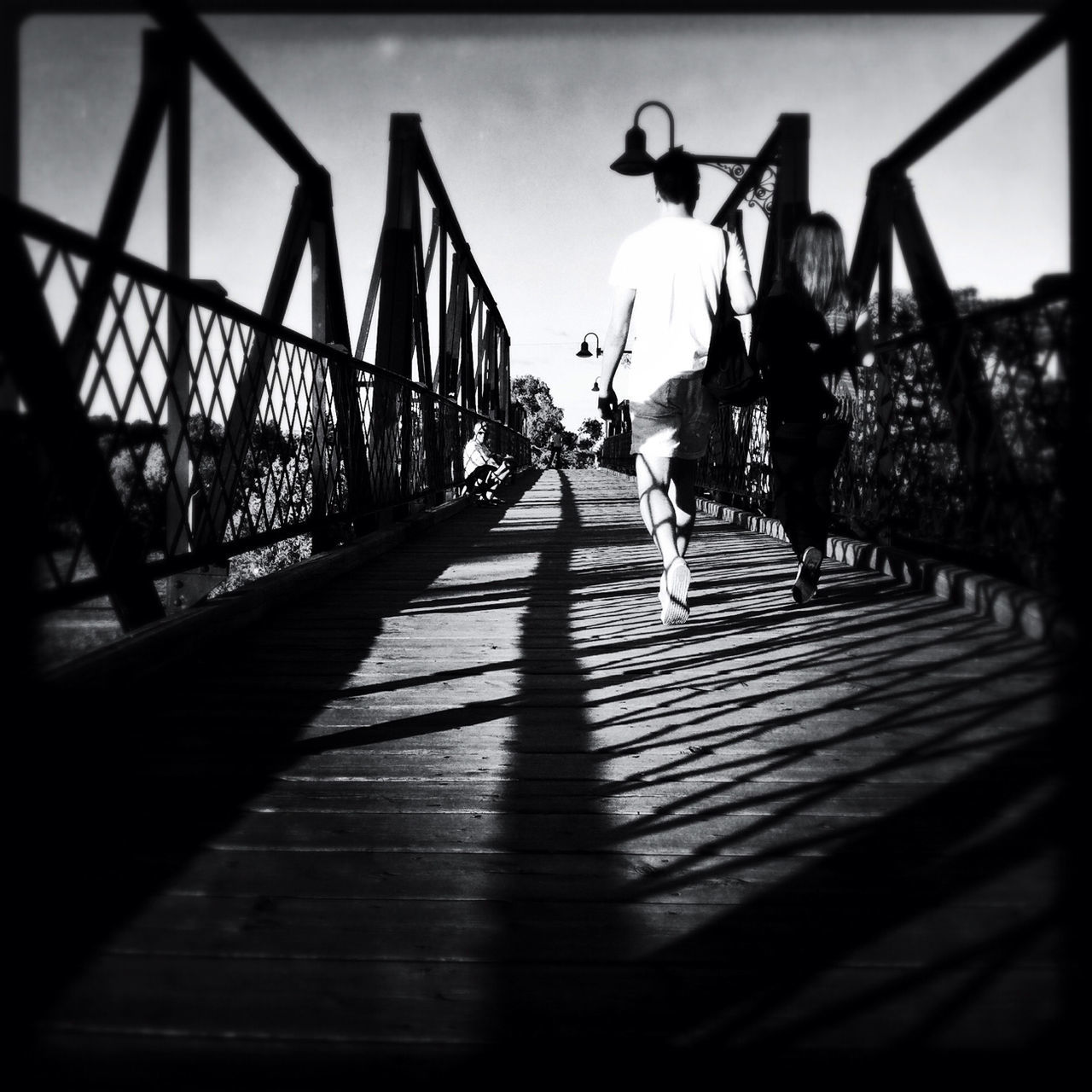 transfer print, lifestyles, auto post production filter, leisure activity, full length, men, walking, person, rear view, childhood, sunlight, shadow, girls, the way forward, casual clothing, sky, railing