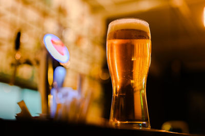 Close-up of beer glass on table