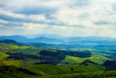 Scenic view of mountains against cloudy sky