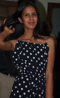 Portrait of a attractive young girl looking at camera with wearing western dress and posing