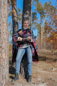 Low angle view of woman standing in forest