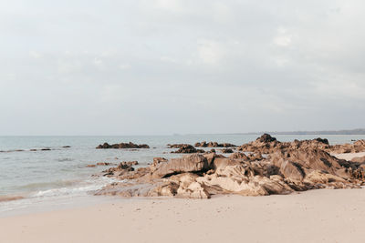 Rocks on beach against sky