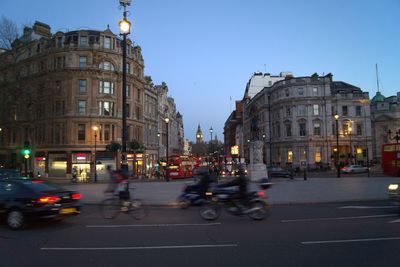 People on city street at dusk