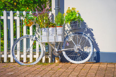 Bicycle parked on footpath by building