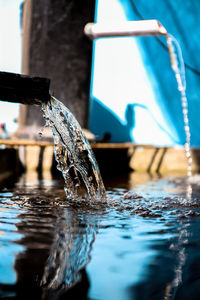 Close-up of water drops on wooden pipe