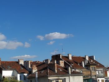 Low angle view of residential buildings against blue sky