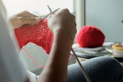 Close-up of woman weaving textile