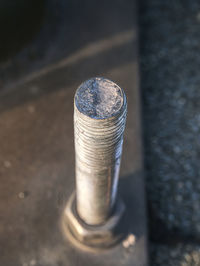 Selective focus. detail of screw fixed metal plate to concrete base.