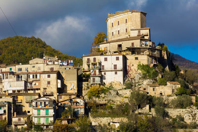 Old buildings in town against sky