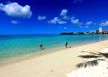 Scenic view of beach against blue sky