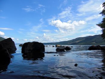 Rocks in sea against sky