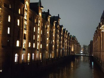 Reflection of buildings in city at night