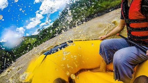 Low section of woman river rafting 