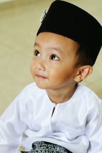 High angle view of boy wearing songkok