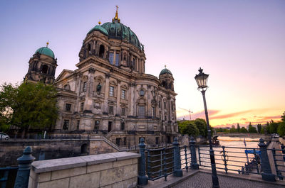 View of buildings in city at sunset