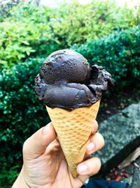 Close-up of hand holding ice cream cone