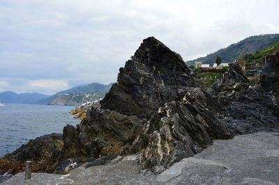 Scenic view of sea and mountains against sky