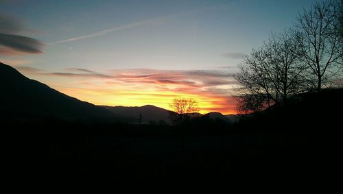 Silhouette landscape against sky during sunset