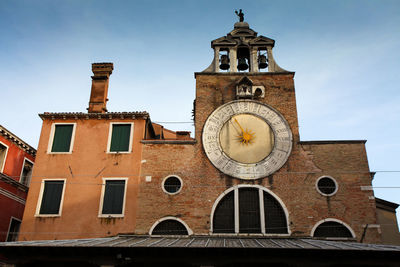 Low angle view of clock tower against sky