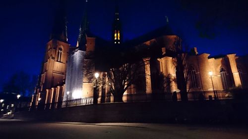 Low angle view of illuminated building against sky at night