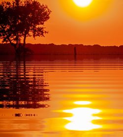 Scenic view of lake against romantic sky at sunset