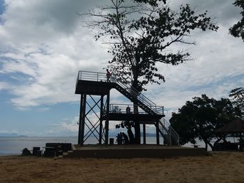 Lifeguard hut at beach against sky