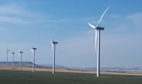 Windmill on field against sky