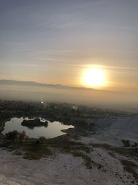 Scenic view of land against sky during sunset