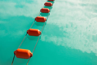 High angle view of ropes buoys in lake
