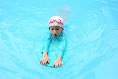 High angle view of girl swimming in pool