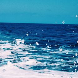 Scenic view of sea against blue sky