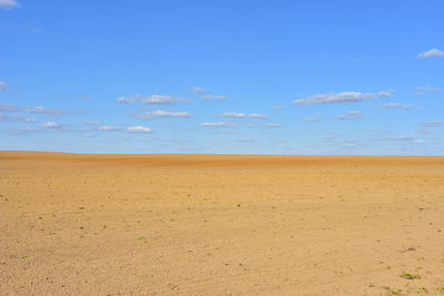 Scenic view of desert against blue sky