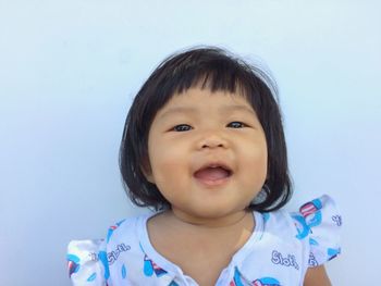 Portrait of smiling boy against white background