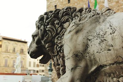 Close-up of statue against building