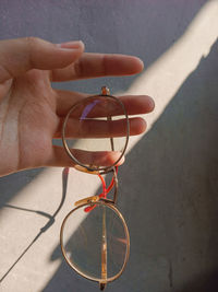 Close-up of hand holding eyeglasses