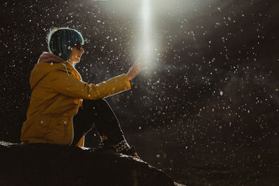 Side view of woman standing on rain