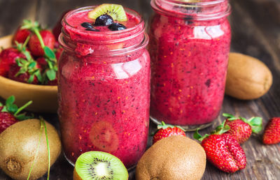 Close-up of strawberries in glass jar on table