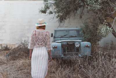 Rear view of woman standing on field