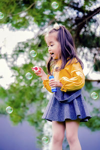 Low angle view of woman with bubbles