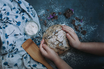 High angle view of woman preparing food on cutting board