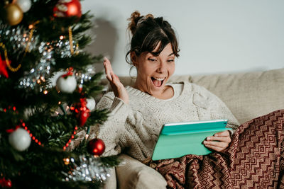 Young woman using digital tablet at home