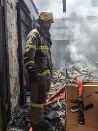 Rear view of fireman worker working at fire location