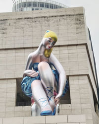 Low angle view of statue sitting on building