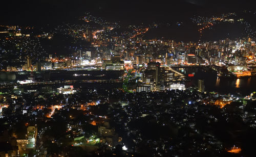 High angle view of illuminated buildings in city at night